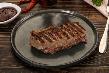 Grilled beef striploin steak with sauce