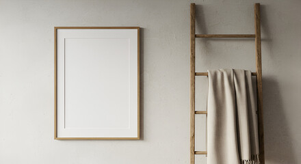 Empty frame on light wall with wooden ladder and blanket