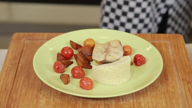 Serving cuscus with grilled vegetables garnish on a plate