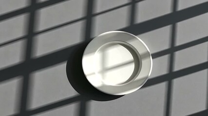 Minimalist aesthetic, white plate on gray background with dynamic shadow overlay and modern look