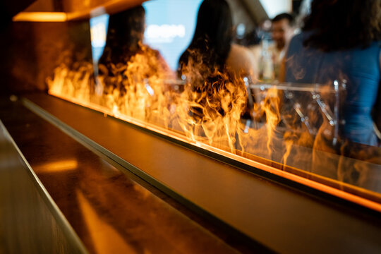 Experience the chic bar interior that features a stunning contemporary fire feature, creating a vibrant and social atmosphere ideal for gathering with friends or celebrating special occasions