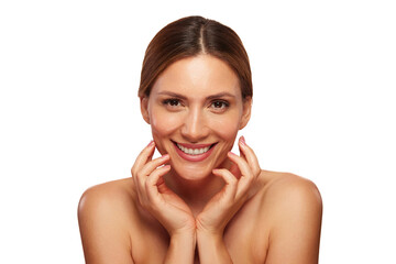 A woman is smiling brightly while gently touching her face, reflecting a sense of joy and...