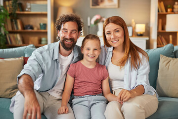 A cheerful family of three, consisting of a father, mother, and daughter, enjoy a happy moment...