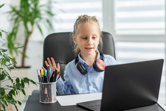 Kid on video call with laptop.