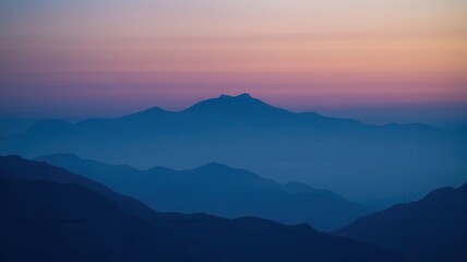 Scenic mountains in shades of blue at dawn with colorful sky gradient