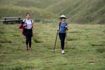 Women hiking in scenic green landscape