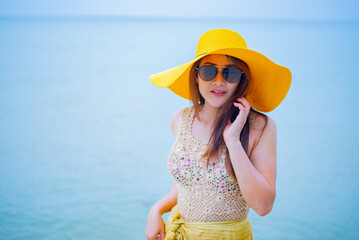 Beautiful Asian women travel alone at the beach on Summer. Holiday and vacation in Thailand.