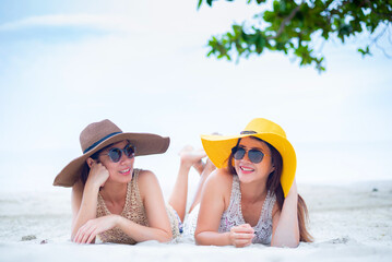 LGBTQ love couples on summer beach. Asian women travel together on holiday.