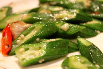 Close-up of stir-fried okra with garlic and red chili in Thai-style home cooking