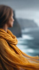 Scarf Fluttering on Cliffside Overlooking Ocean Waves