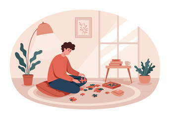 A young man sits on a cushion on the floor, focused on assembling a jigsaw puzzle in a cozy room.