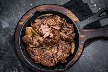 Beef bourguignon stew with tender beef in a pan. black background. top view