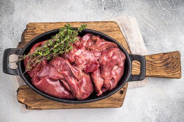 Freshly sourced poultry liver, chicken offals waiting to be transformed into a delicious dish. grey background. top view