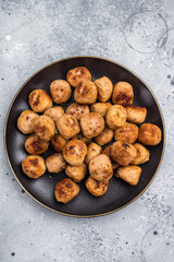Savory meatballs, meat dumplings garnished with fresh herbs. A delightful addition to any meal, bringing warmth and satisfaction to the table. grey background. top view