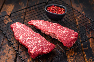 Beef shoulder tender, raw denver steak waiting to be transformed into a gourmet dish. Ideal for grilling or roasting for an unforgettable dinner. wooden background. top view
