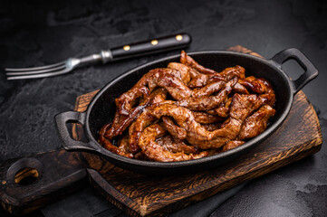 Korean Beef  Meat Bulgogi Hot Plate. black background. top view