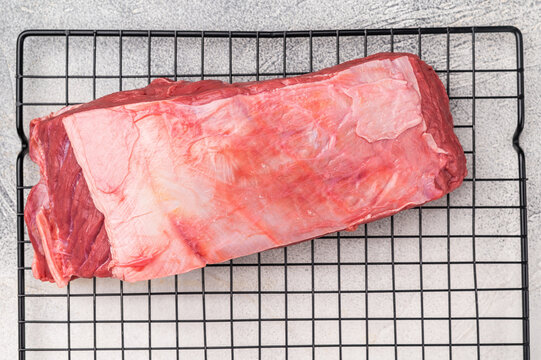 Close-up of raw buffalo meat cuts, highlighting the marbling and vibrant hue, perfect for creating delicious and nutritious dishes. grey background. top view
