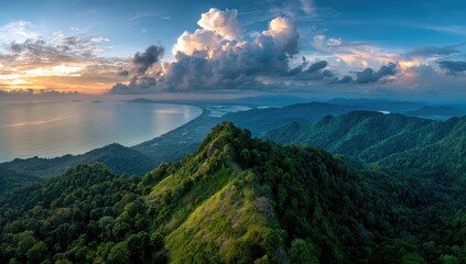 Panoramic sunset view over a lush mountain range meeting a tranquil bay