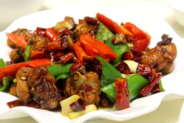 Authentic Chongqing spicy chicken stir fry with dried red chilies and bell peppers