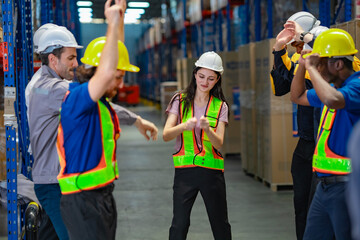 Diverse employees express happiness through fun dance moves in the warehouse, symbolizing workplace morale and success celebration.