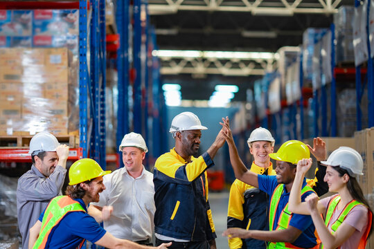Smiling multicultural team in safety gear. Useful for HR content, company culture, and logistics team spirit.
