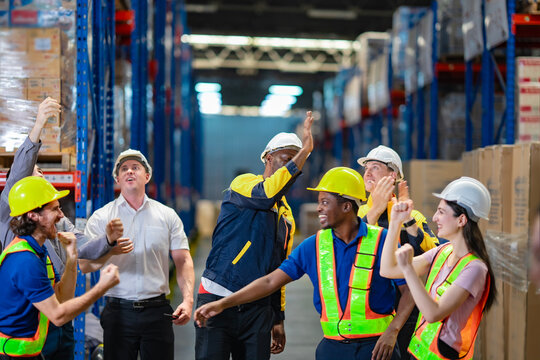 Industrial success shown through teamwork and unity. International warehouse team standing proud and congrate after achievement.