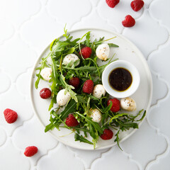 Arugula salad with mozzarella and raspberry