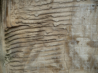 Abstract stone background of old rough plaster. Stripes are visible on the surface - grooves and imprints of the back side of the tile.