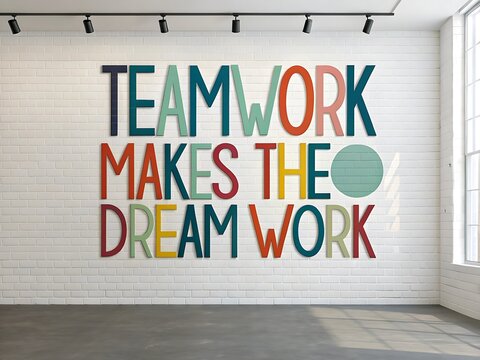 Inspirational teamwork makes the dream work quote painted on a white brick wall