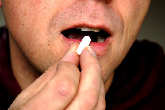 Man taking a pill.