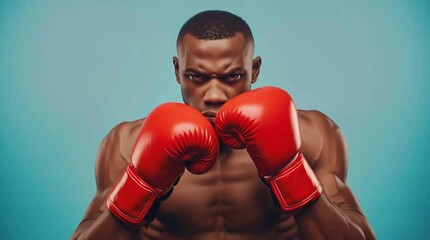Boxer with red gloves in fighting stance showing strength determination and athletic focus against blue background for sports training and motivation concept - Powered by Adobe