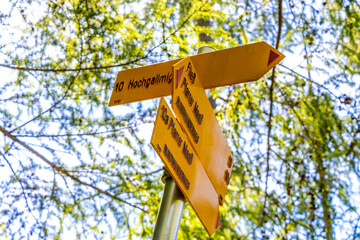 Yellow arrow location and hiking sign direction in Tyrol Austria.