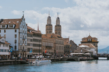 Grossmunster reflecting on limmat river in zurich, switzerland