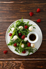 Arugula salad with mozzarella and raspberry