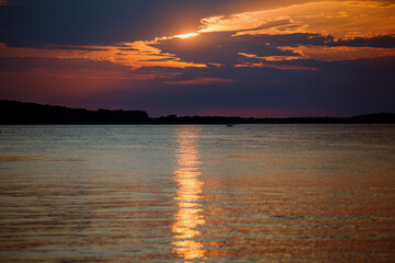 Sky with light clouds over the sea. Beautiful sunset on a summer evening. Ships