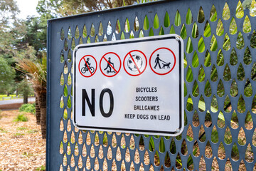 Warning sign at the entrance of Geelong Botanic Gardens in Australia. The sign prohibits bicycles,...