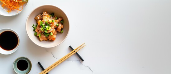 Delicate bowl of natto with green onions and soy sauce on a marble surface