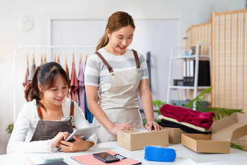 Asian Women business owner working at home with packing box on workplace - online shopping SME...