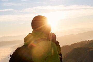 An extreme mountaineer, equipped with professional gear, pushes towards the peak of the mountain at...