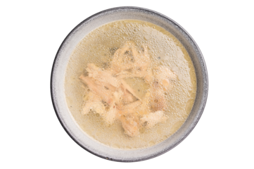 Bowl of chicken broth with meat isolated on white background. top view