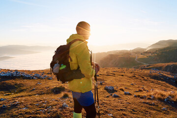 An extreme mountaineer, equipped with professional gear, pushes towards the peak of the mountain at...