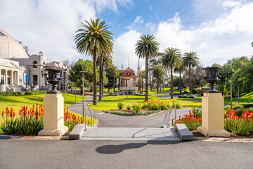 Johnstone Park in Geelong, Victoria, Australia, featuring a symmetrical pathway leading to a historic rotunda and the heritage gallery building. The civic park is a peaceful public garden in town.