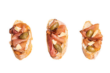 Bruschetta with Prosciutto ham, parmesan cheese and olives isolated on white background. top view