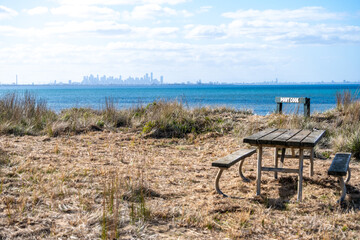  A picnic table and benches overlook the blue waters of Point Cooke Marine Sanctuary and...
