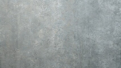 A closeup of a gray concrete wall with a rough textured surface creates a grunge background