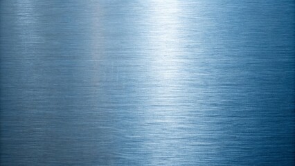 A closeup of a brushed metal surface shows horizontal grain and a subtle reflective gradient of light