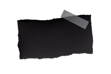 壁にテープで貼られた、黒い紙の断片