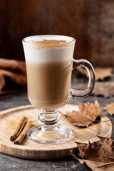 Maple Latte with Cinnamon in Glass Mug on wooden table