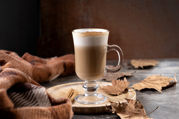 Maple Latte with Cinnamon in Glass Mug on wooden table