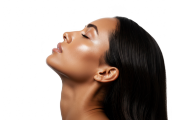 A stunning young woman with radiant skin is posing with her eyes closed in a studio